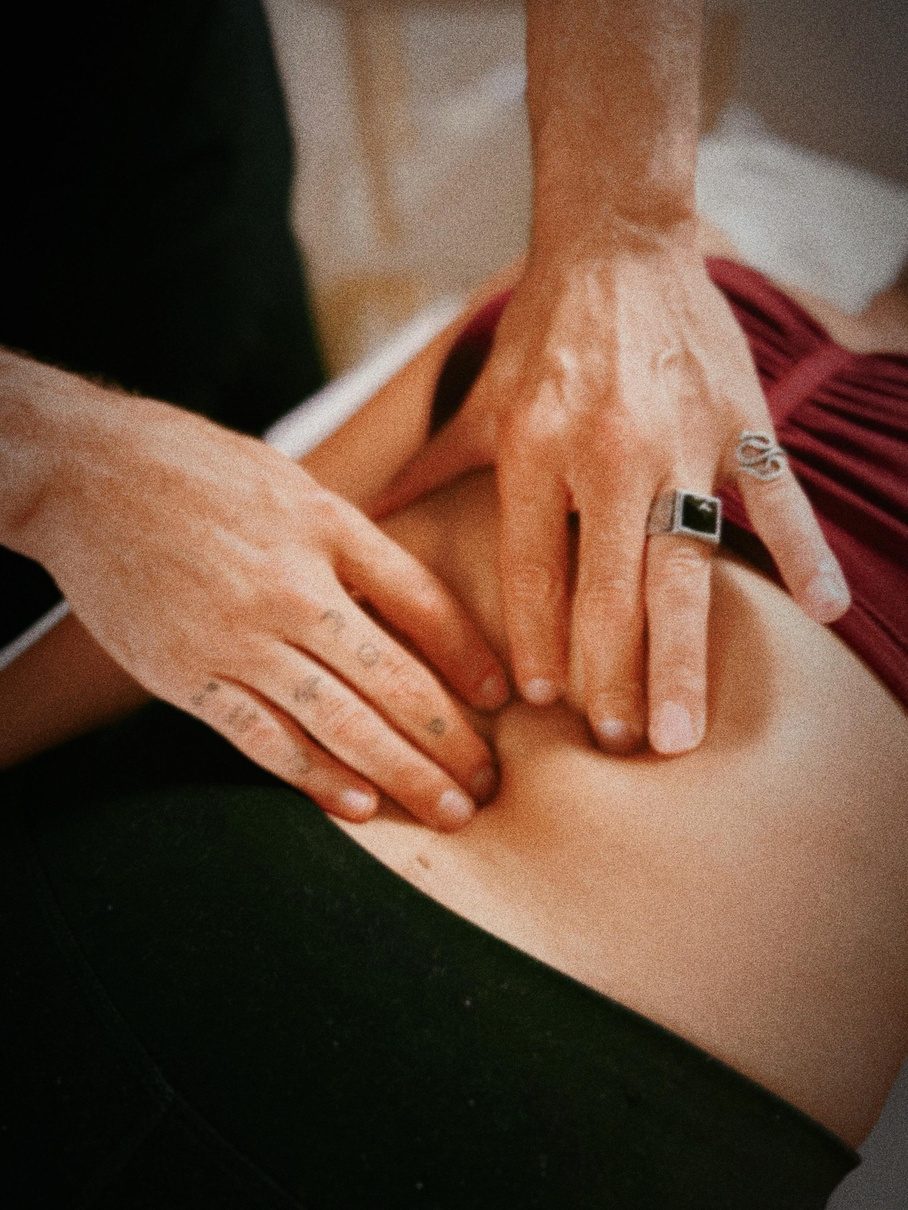 Hands working along a client's back