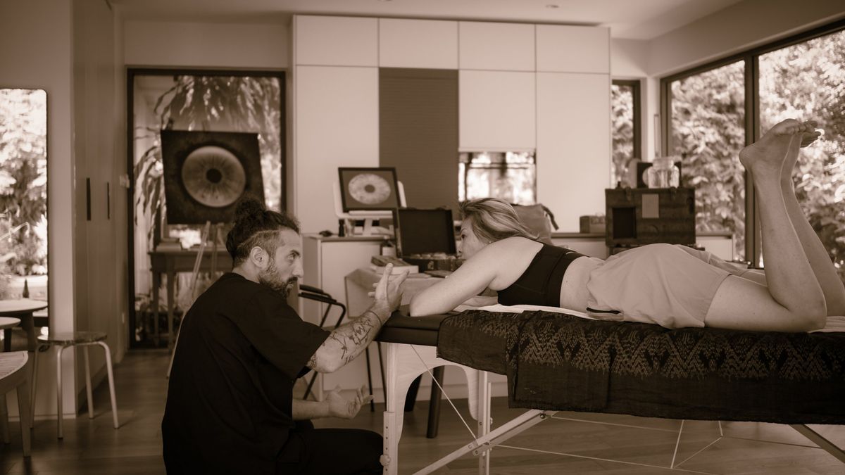 Nad coaching a client on the treatment table