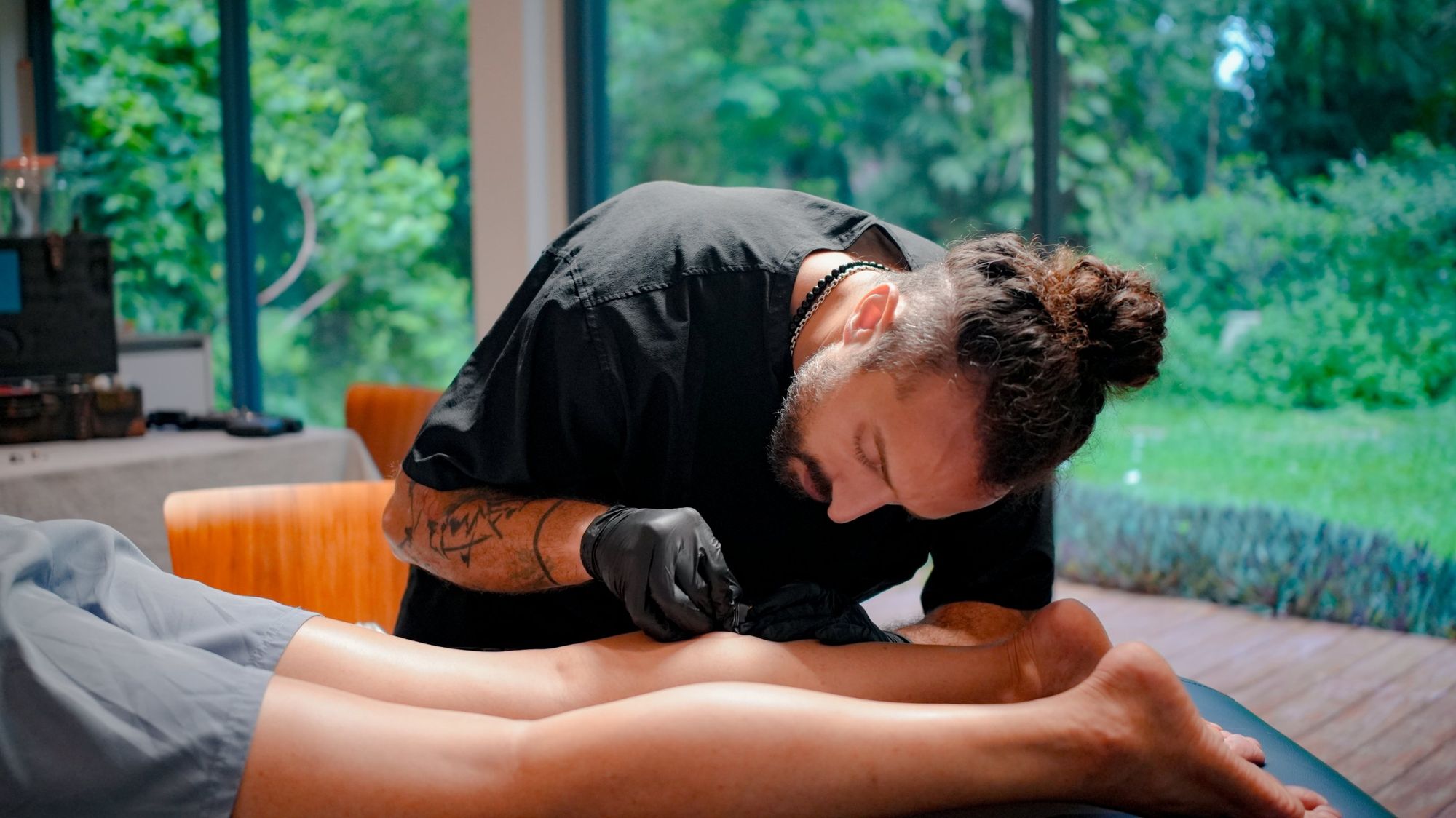 Nad Marwani working with a client during a Private Healing Immersion, garden view behind